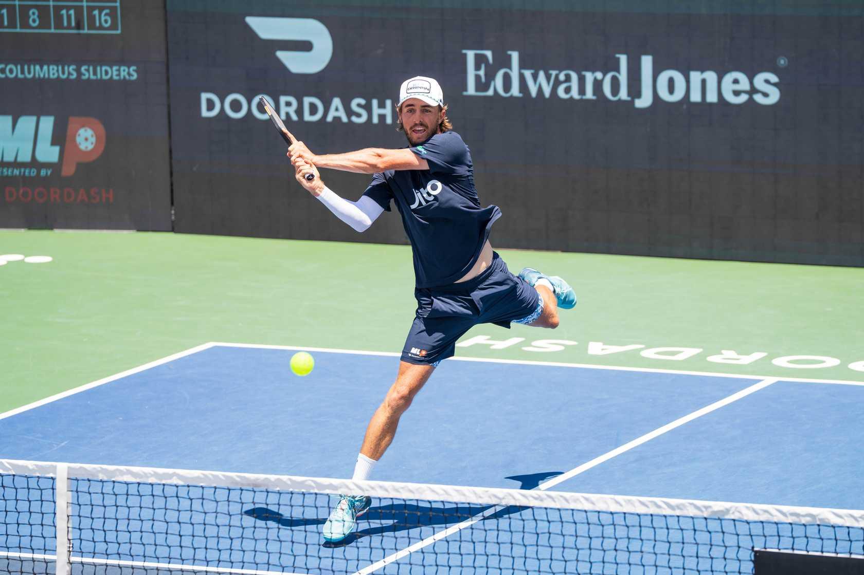 Hunter Johnson hitting a backhand.